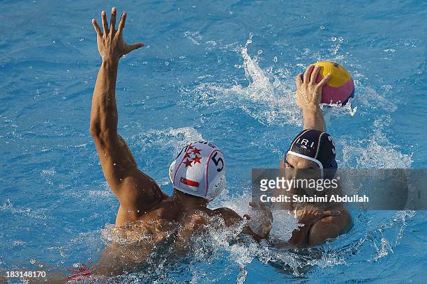 Seyed Mir Mehdi Mohammadsaeid of Iran looks for a pass against Lim Yao Xiang of Singapore during the finals of the Asian Water Polo Cup between...