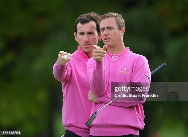 Gonzalo Fernandez Castano and Nicolas Colsaerts of the European team line up a putt during the third day's morning foursomes at the Seve Trophy at...