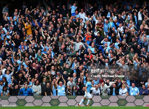 Manchester City fans celebrate after Sergio Aguero of Manchester City scores their team's second goal during the Barclays Premier League match...