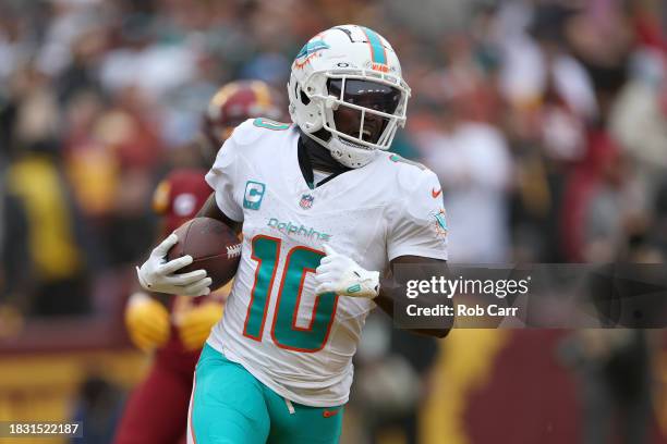 Wide receiver Tyreek Hill of the Miami Dolphins catches and runs for a touchdown pass in front of cornerback Kendall Fuller of the Washington...