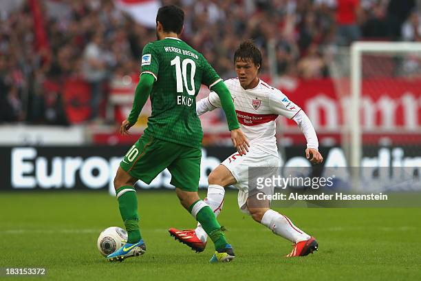 Gotoku Sakai of Stuttgart battles for the ball with Mehmet Ekici of Bremen during the Bundesliga match between VfB Stuttgart and SV Werder Bremen at...