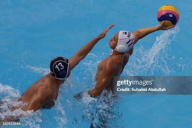 Yip Yang of Singapore looks for a pass against Amirhossein Ghahjavarestani Khani of Iran during the finals of the Asian Water Polo Cup between...