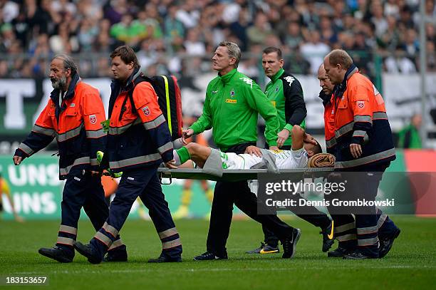 Alvaro Dominguez Soto of Borussia Moenchengladbach is brought off the pitch on a stretcher after suffering an injury during the Bundesliga match...