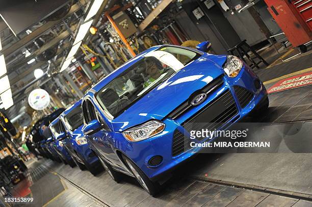 By Mira OBERMAN, US-auto-history-company-Ford An auto worker drives a newly-built Focus off the line at Ford's Michigan Assembly Plant on October 1...