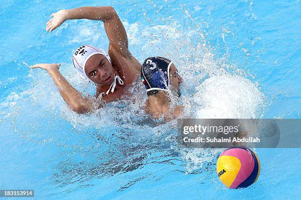 Seyed Mir Mehdi Mohammadsaeid of Iran and Yip Yang of Singapore challenge for the ball during the finals of the Asian Water Polo Cup between...