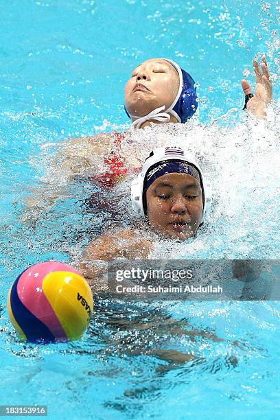 Sineenart Sonthipakdee of Thailand and Yan Jing of China challenge for the ball during the women Asian Water Polo Cup between Thailand and China at...