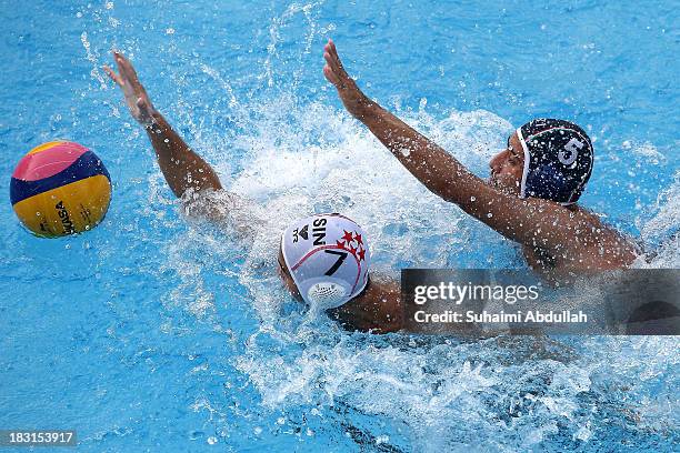 Hamed Khanbanan Malak of Iran and Chiam Kun Yang of Singapore challenge for the ball during the finals of the Asian Water Polo Cup between Singapore...