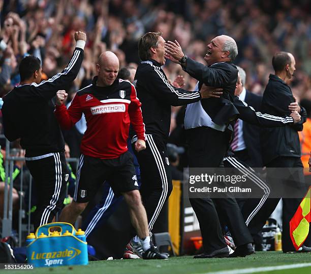 Fulham manager Martin Jol celebrates the goal scored by Darren Bent of Fulham with support staff during the Barclays Premier League match between...