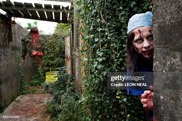 Volunteer "zombie" poses for a picture as she waits for participants during one of Britain's biggest horror events, the "Zombie Evacuation Race" at...