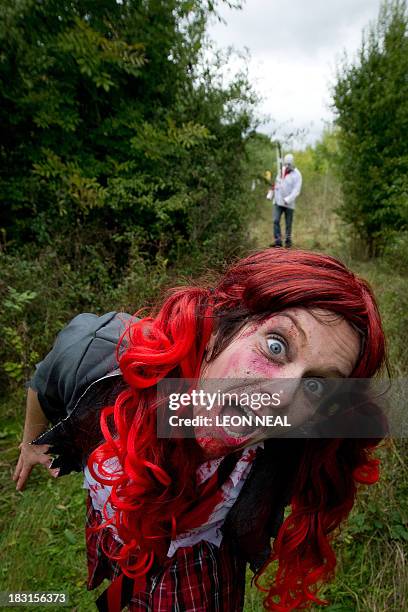 Volunteer "zombie" poses for a picture as she waits for participants during one of Britain's biggest horror events, the "Zombie Evacuation Race" at...