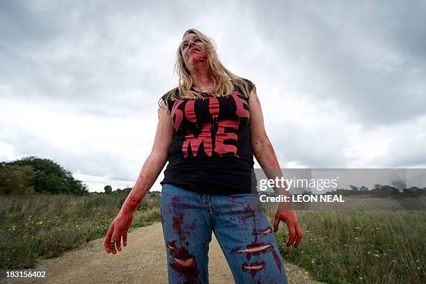 Volunteer "zombie" waits for participants during one of Britain's biggest horror events, the "Zombie Evacuation Race" at Carver Barracks near Saffron...