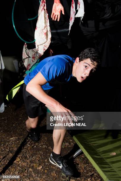 Participants rush through a destroyed medical section during one of Britain's biggest horror events, the "Zombie Evacuation Race" at Carver Barracks...