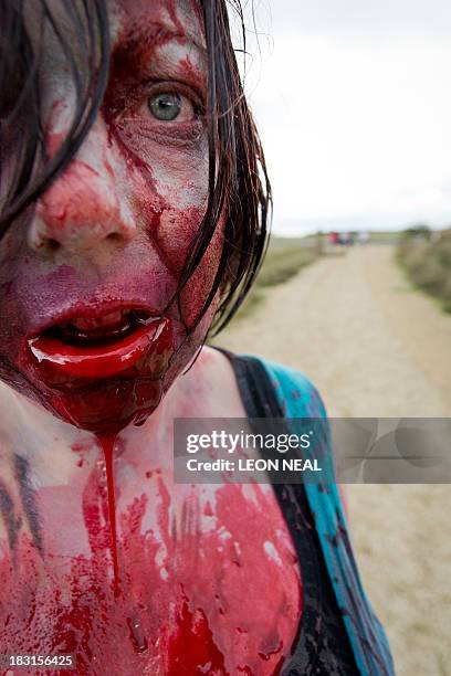 Volunteer "zombie" waits for participants during one of Britain's biggest horror events, the "Zombie Evacuation Race" at Carver Barracks near Saffron...