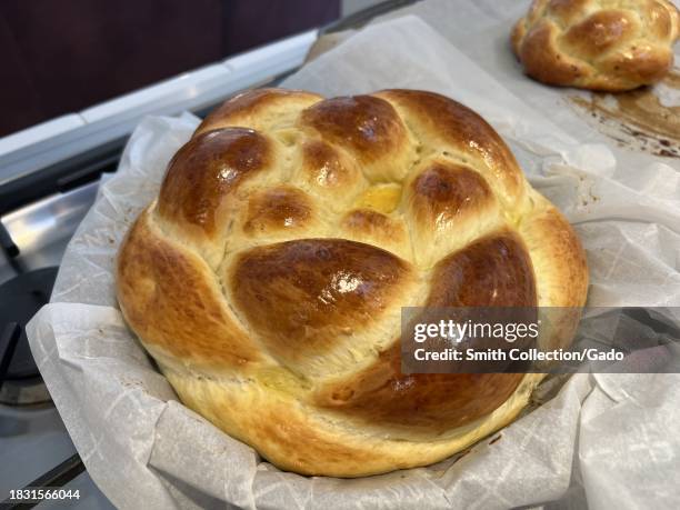 Freshly baked challah bread on parchment paper, a traditional braided loaf, California, September 15, 2023.