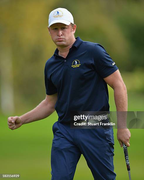 Jamie Donaldson of Great Britain and Ireland team celebrates during the third day's afternoon foursomes at the Seve Trophy at Golf de...