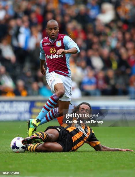 Fabian Delph of Aston Villa tackles Tom Huddlestone of Hull City during the Barclays Premier League match between Hull City and Aston Villa at KC...