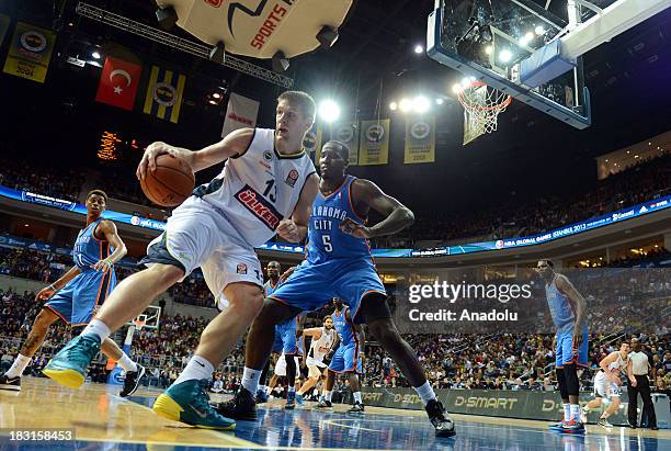 Gasper Vidmar of Fenerbahce Ulker controls the ball next to Kendrick Perkins of Oklahoma City Thunder during the NBA Global Games match between...