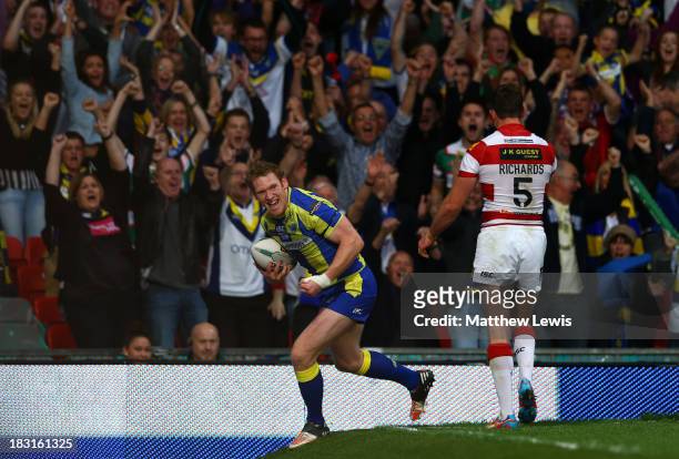 Joel Monaghan of Warrington celkebrates after scoring his team's first try during the Super League Grand Final between Warrington Wolves and Wigan...