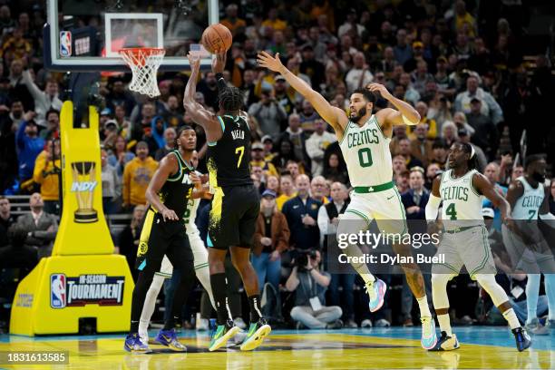 Buddy Hield of the Indiana Pacers attempts a shot while being guarded by Jayson Tatum of the Boston Celtics in the fourth quarter during the NBA...