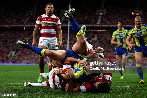 Simon Grix of Warrington crashes through the Wigan defence to score his team'ssecond try during the Super League Grand Final between Warrington...