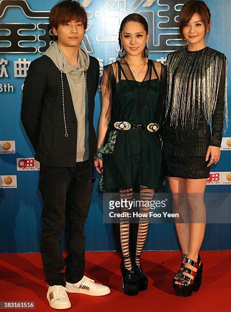 Adason Loi ,Gillian and Charlene Choi of Hong Kong poses during the red capet prior to the start of the 13th Global Chinese Music Awards at Putra...