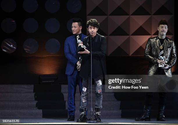 Michael Wong of Malaysia shows off his one of the Top 20 Song Award during the 13th Global Chinese Music Awards at Putra Stadium on October 5, 2013...