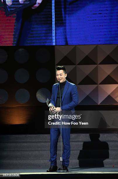 Lam Fong of Hong Kong speaks after he received the Award of his song in the top 20 of the year during the 13th Global Chinese Music Awards at Putra...