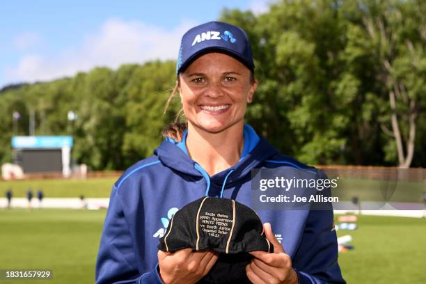 Suzie Bates of New Zealand poses for a photo with a cap which recognises 300 appearances during game two of the T20 International Women's series...