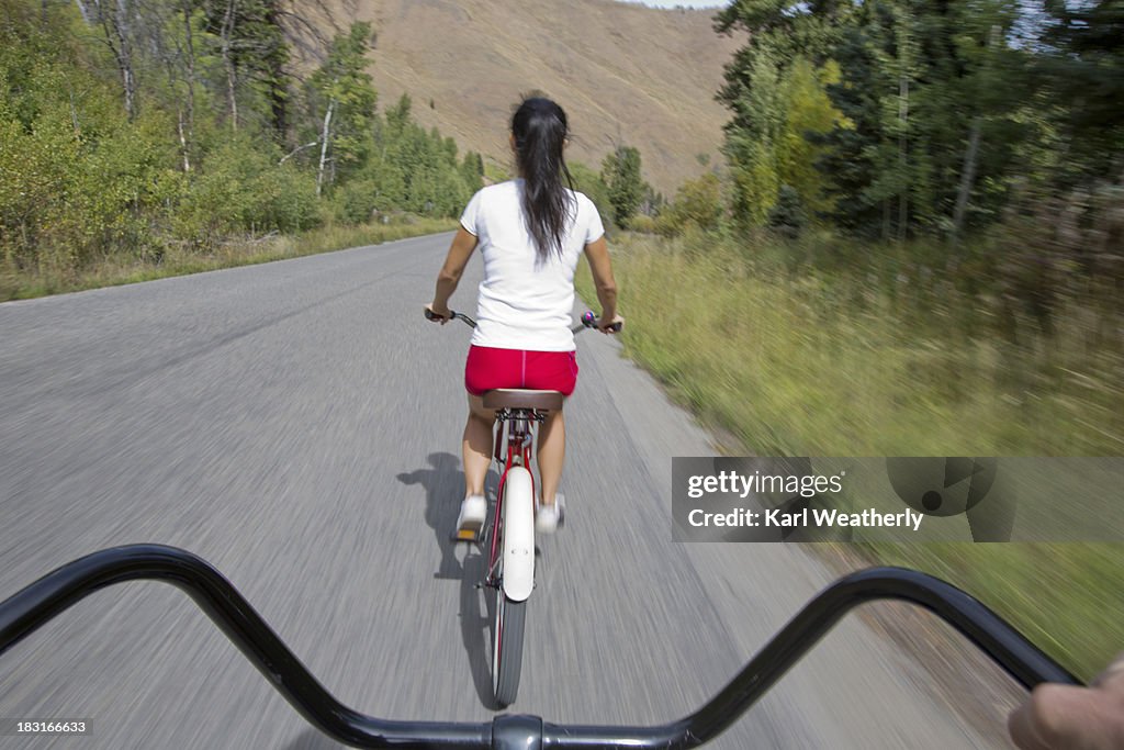 Point of view of riding bike with woman in front