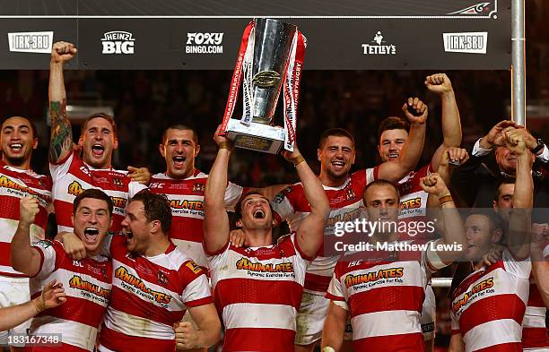 Captain Sean O'Loughlin of Wigan lifts the trophy following his team's 30-16 victory during the Super League Grand Final between Warrington Wolves...