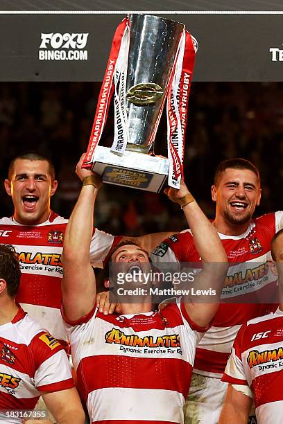 Captain Sean O'Loughlin of Wigan lifts the trophy following his team's 30-16 victory during the Super League Grand Final between Warrington Wolves...