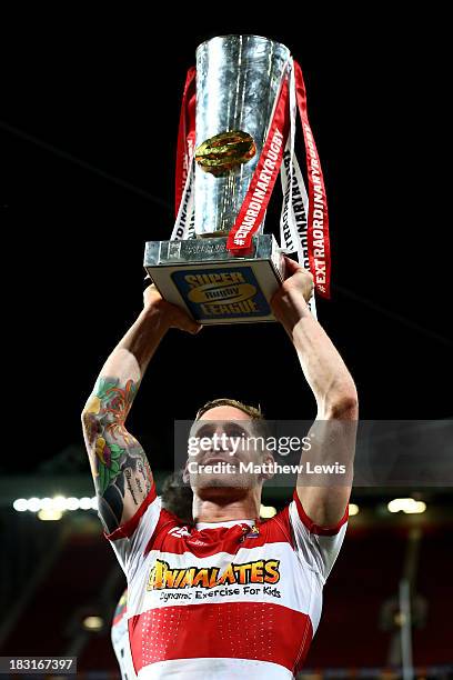 Sam Tomkins of Wigan celebrates with the trophy following his team's 30-16 victory during the Super League Grand Final between Warrington Wolves and...