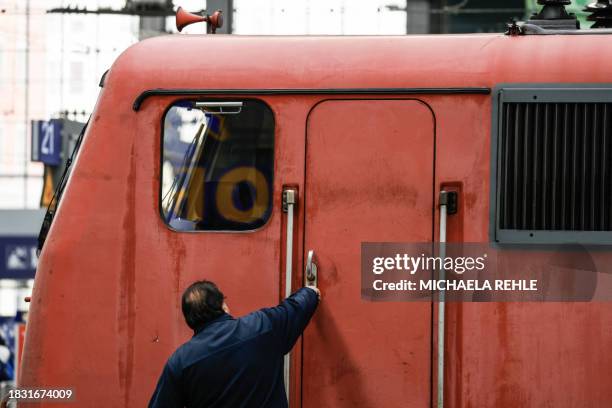 An engine driver locks the cabin of his train in the main train station of Munich, southern Germany, during a wage strike by German train drivers on...