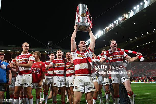 Matty Smith of Wigan Warriors lifts the winners trophy after his sides 30-16 victory during the Super League Grand Final between Warrington Wolves...