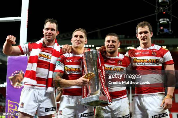 Pat Richards, Sam Tomkins, Michael McIlorum and Sean O'Loughlin of Wigan celebrate with the trophy following their team's 30-16 victory during the...