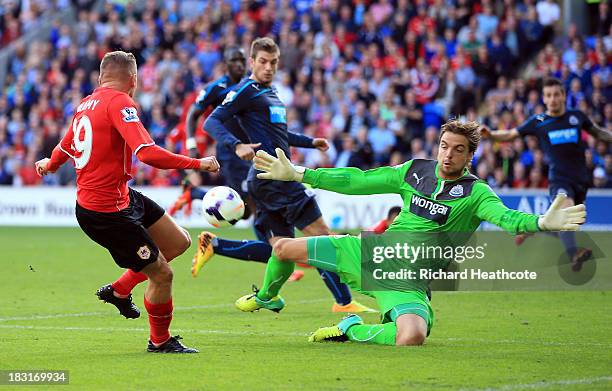 Tim Krul of Newcastle United stops a shot from Craig Bellamy of Cardiff City during the Barclays Premier League match between Cardiff City and...