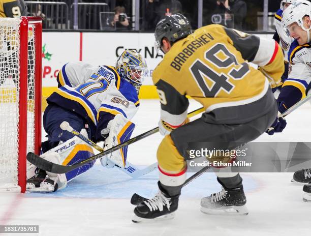 Jordan Binnington of the St. Louis Blues makes a save against Ivan Barbashev of the Vegas Golden Knights in the second period of their game at...