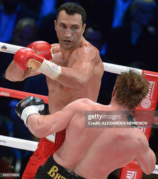 Ukrainian heavyweight boxing world champion Vladimir Klitschko fights with Russian heavyweight boxer Alexander Povetkin in Moscow on October 5, 2013....