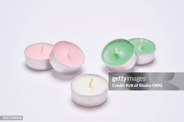 the aromatic tea candles on the white background - tealight stock pictures, royalty-free photos & images