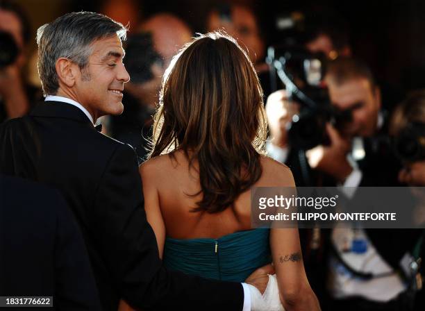 Actor George Clooney and girlfriend Elisabetta Canalis arrive for the screening of "The men who stare at goats" at the Venice film festival on...