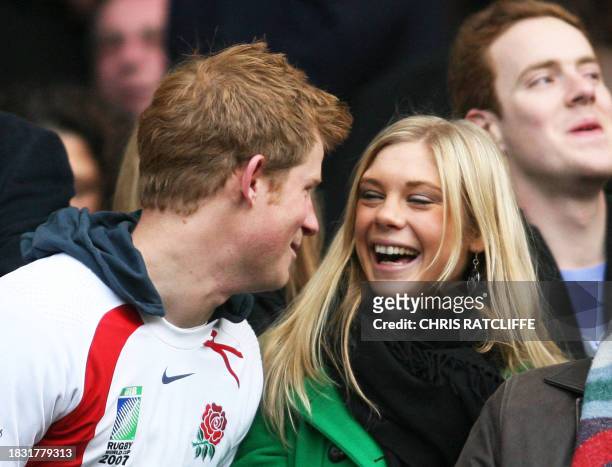 Britain's Prince Harry and Chelsy Davy laugh before the game between South Africa and England at the Investec Challenge international rugby match at...
