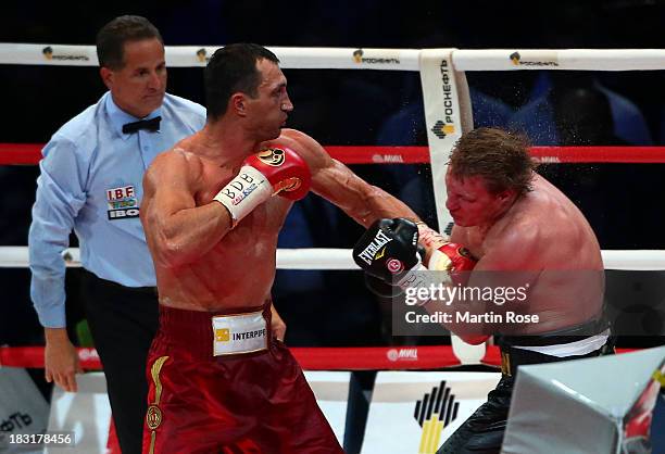 Wladimir Klitschko of Ukraine exchanges punches with Alexander Povetkin of Russia during their WBO, WBA, IBF and IBO heavy weight title fight between...