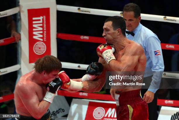 Wladimir Klitschko of Ukraine exchanges punches with Alexander Povetkin of Russia during their WBO, WBA, IBF and IBO heavy weight title fight between...