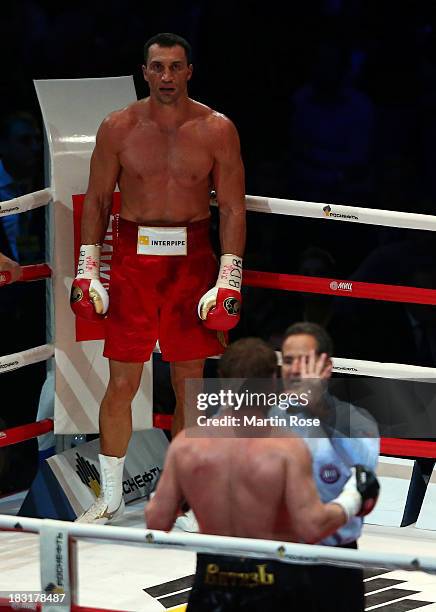 Referee Luis Pabon of Costa Rica counts to Alexander Povetkin of Russia during their WBO, WBA, IBF and IBO heavy weight title fight between Wladimir...