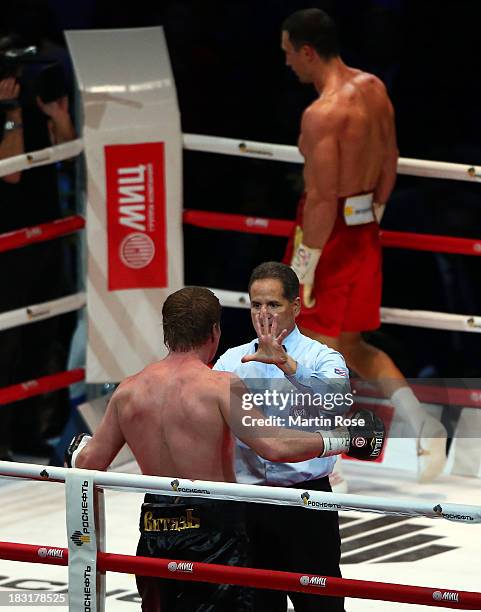 Referee Luis Pabon of Costa Rica counts to Alexander Povetkin of Russia during their WBO, WBA, IBF and IBO heavy weight title fight between Wladimir...