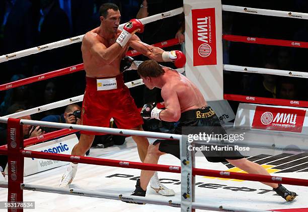 Wladimir Klitschko of Ukraine exchanges punches with Alexander Povetkin of Russia during their WBO, WBA, IBF and IBO heavy weight title fight between...