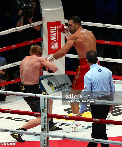 Wladimir Klitschko of Ukraine exchanges punches with Alexander Povetkin of Russia during their WBO, WBA, IBF and IBO heavy weight title fight between...