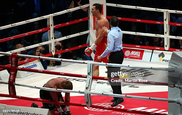 Alexander Povetkin of Russia lies on the floor during tje 3rd round during their WBO, WBA, IBF and IBO heavy weight title fight between Wladimir...