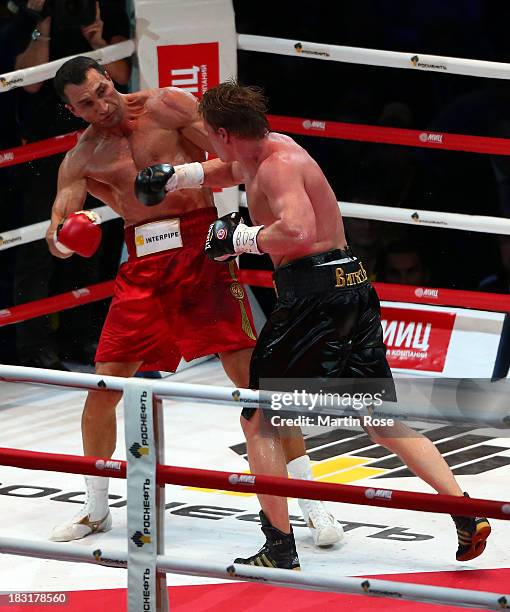 Wladimir Klitschko of Ukraine exchanges punches with Alexander Povetkin of Russia during their WBO, WBA, IBF and IBO heavy weight title fight between...