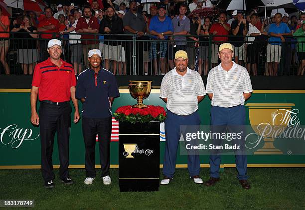 Matt Kuchar and Tiger Woods of the U.S. Team pose for a photo with Brendon de Jonge and Ernie Els of the International Team on the first hole during...